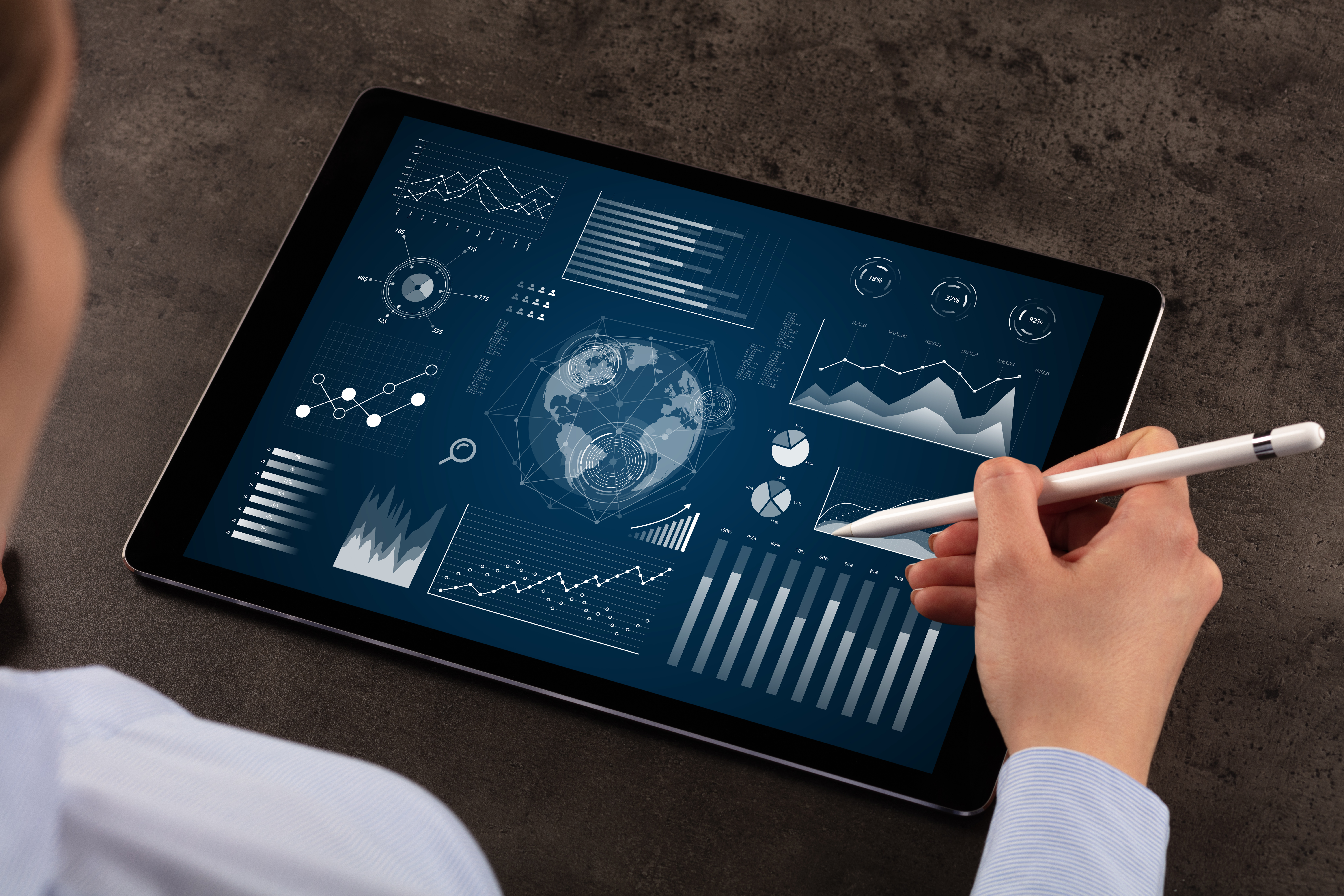 Business woman verifying reports Business woman verifying reports on tablet with pencil in business suit